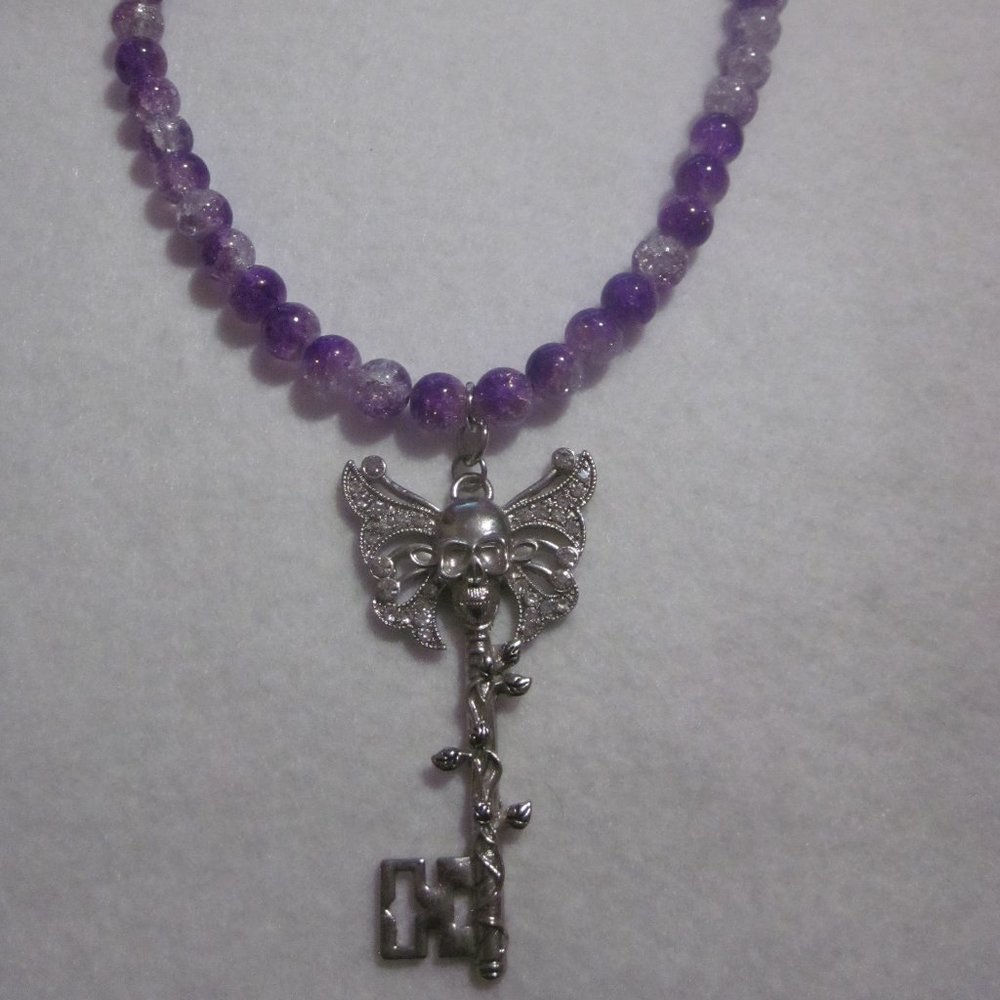 Purple and Clear Two Tone Crackle Skull Key Necklace.